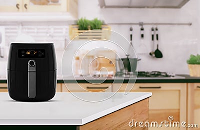 Air fryer machine cooking potato fried in kitchen. Lifestyle of new normal cooking Stock Photo