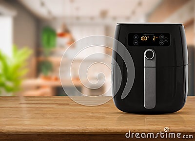 Air fryer machine cooking potato fried in kitchen. Lifestyle of new normal cooking Stock Photo