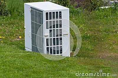 Air heat pump unit in the garden Stock Photo