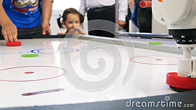Air hockey table and person`s hand playing with white robot arm. Media. Different working robots collection presented on Editorial Stock Photo