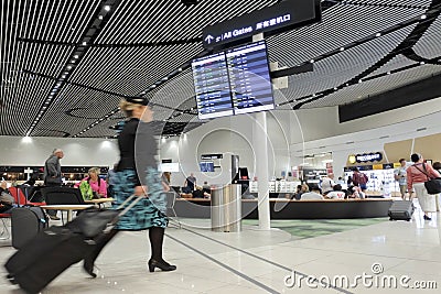 Air New Zealand flight attendant passing through the new Auckland airport International departure area Editorial Stock Photo