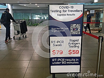 Air passengers passing by COVID -19 PCR swab test sign in Brisbane Airport Queensland Australia Editorial Stock Photo