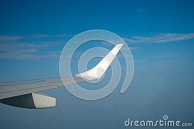 Air plain wing over blue sunny sky Stock Photo