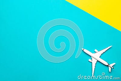 Air plane sky travel. White toy airplane on bright blue and yellow background. abstract flight and fly aircraft concept. Stock Photo