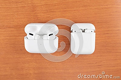 Air Pods Pro. with Wireless Charging Case. New Airpods pro on wooden background. Air pods. Copy space Stock Photo