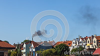 Air pollution, black smoke from chimney over urban area Stock Photo