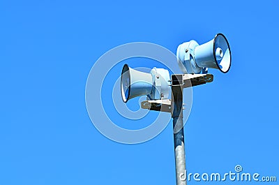 Air raid siren against blue sky Stock Photo