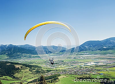 Air sportsman fly on paraplane over the mountain valley Stock Photo