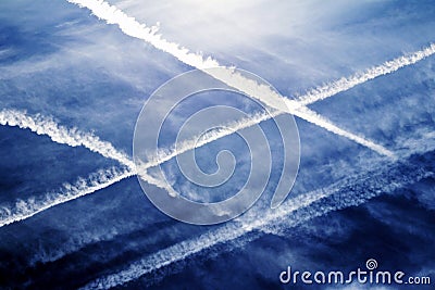 Air traffic congested Airplanes traces in blue Sky Stock Photo