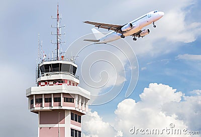 Air traffic control tower in international airport with passenger airplane jet taking off Stock Photo