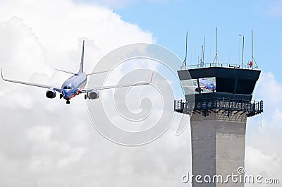 Air traffic control tower with jet airplane Stock Photo