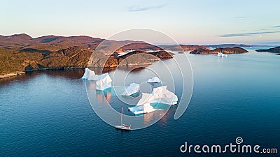 Air view to icebergs and yacht. Amazing Greenland. Stock Photo