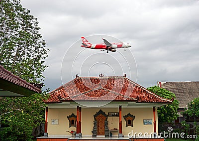 AirAsia Airbus A320 passing over the Hindu temple Editorial Stock Photo