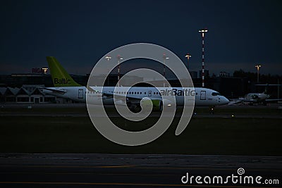 AirBaltic airline Airbus A220-300 aircraft on the runway of Riga International Airport at night. Riga International Airport, Editorial Stock Photo