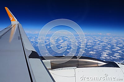 Aircraft engine and wing on the border of atmosphere and space. The edge of the troposphere. Horizon over the Earth Editorial Stock Photo