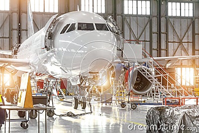 Aircraft jet on maintenance of engine and fuselage check repair in airport hangar Editorial Stock Photo