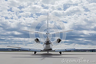 Aircraft learjet Plane in front of the Airport with cloudy sky Stock Photo