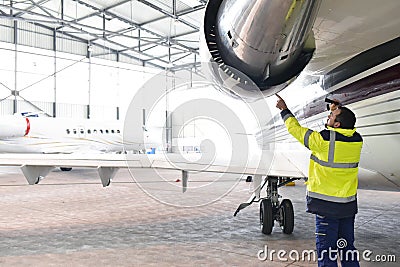 Aircraft mechanic/ ground crew inspects and checks the turbine Stock Photo