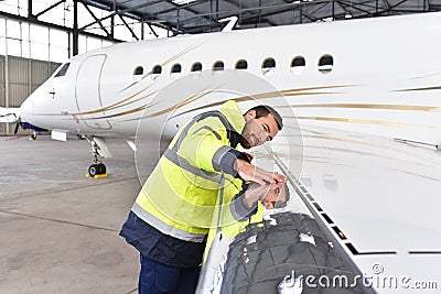 Aircraft mechanic inspects and checks the technology of a jet in Stock Photo