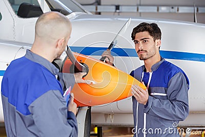 Aircraft mechanics holding propeller Stock Photo