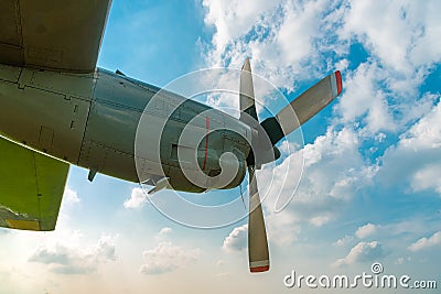 Aircraft Propeller and Spinner Engine on Airplane Wing Against Cloudy Blue Sky. Stock Photo