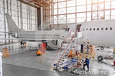 Aircraft during repair, technical inspection is a working technician. View of nose, a cockpit with a staircase leading into the en Editorial Stock Photo