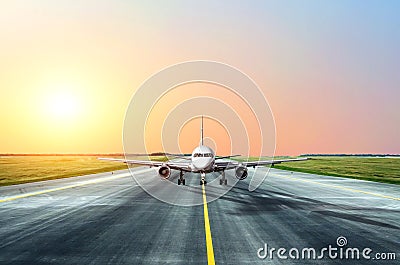 Aircraft taxis after landing in the evening at sunset at the airport. Stock Photo