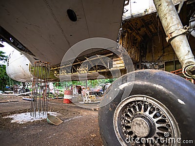 Aircraft Tires Under Repair on an Old Junkyard. Rusty and Broken Retractable Hydraulically Operated Airplane Wheel. Stock Photo