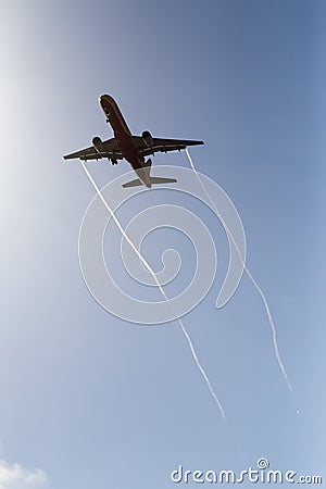 Aircraft with vapor trails Editorial Stock Photo