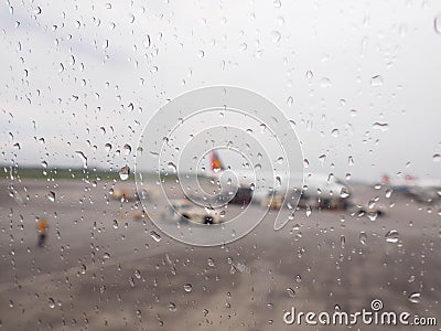 Aircraft Window with plane with rainy window and raindrops Stock Photo