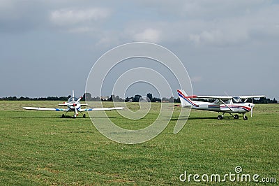 Aircrafts on a grass airfield Stock Photo