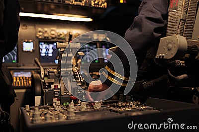 Aircrew member using control panel command on dashboard Stock Photo