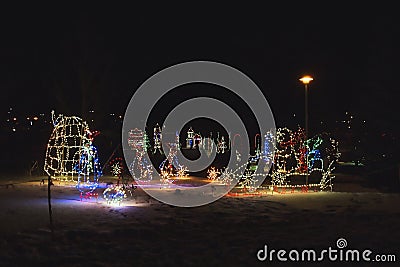 Led lights form a snow sled figure with a bear and penguins as Christmas decoration Editorial Stock Photo