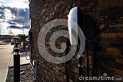 Tesla level 2 chargers mounted on a brick wall for EV charging Editorial Stock Photo