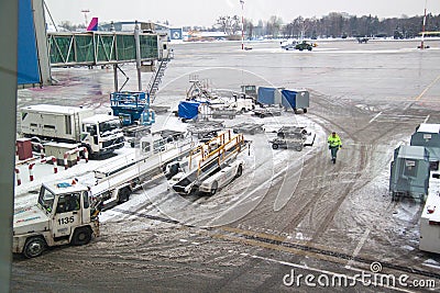 Airdrome machines under plane wing on winter. Editorial Stock Photo