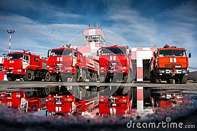 Airfield fire trucks with reflection in a puddle Stock Photo