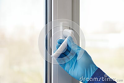 Airing the room. hands in rubber gloves open the window Stock Photo