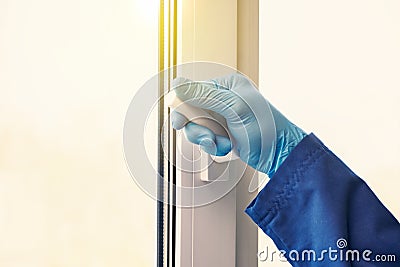 Airing the room. hands in rubber gloves open the window Stock Photo