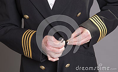 Airline pilot fastening uniform jacket Stock Photo