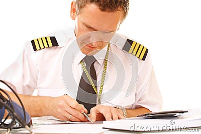 Airline pilot filling in papers Stock Photo