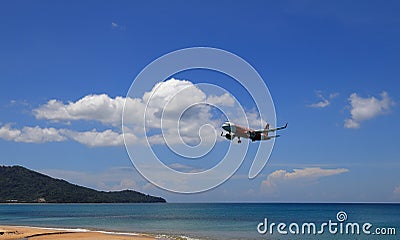 Airliner or Passenger plane Air Asia Airbus A320 landing to airport next to the beach. Editorial Stock Photo