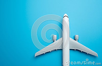 Airliner plane on a blue background and place for text. Traveling by plane. Booking tickets and accumulating air mile bonuses. Stock Photo