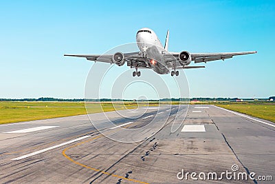 Airplane aircraft flying departure after flight, landing on a runway in the good weather clear sky day. Stock Photo