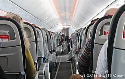 Airplane cabin aisle with rear view and seats Editorial Stock Photo