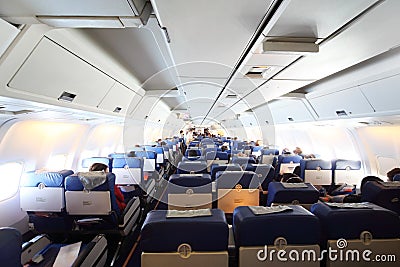 Airplane cabin with passengers Stock Photo