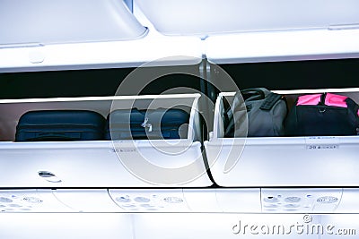Airplane cabine with the luggage compartments Stock Photo