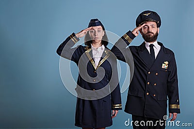 Airplane captain and stewardess saluting portrait Stock Photo