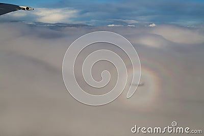 Airplane in the clouds with glory. Stock Photo