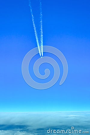 Airplane with contrails Stock Photo