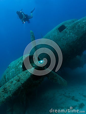 Diver exploring wreck of aircraft Stock Photo